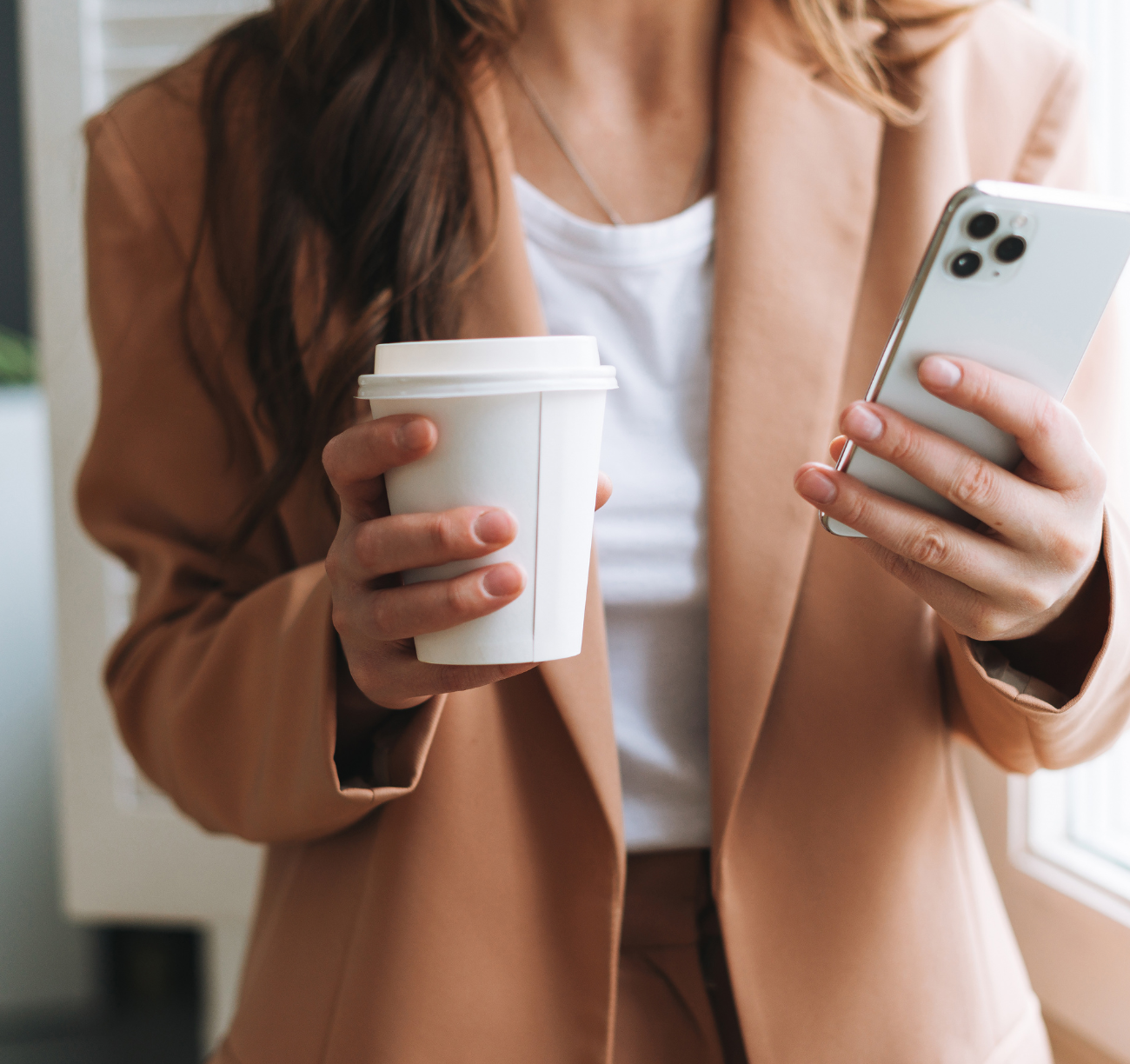 Woman holding phone and coffee, applying for home loan online. Woman holding phone and coffee, applying for home loan online.