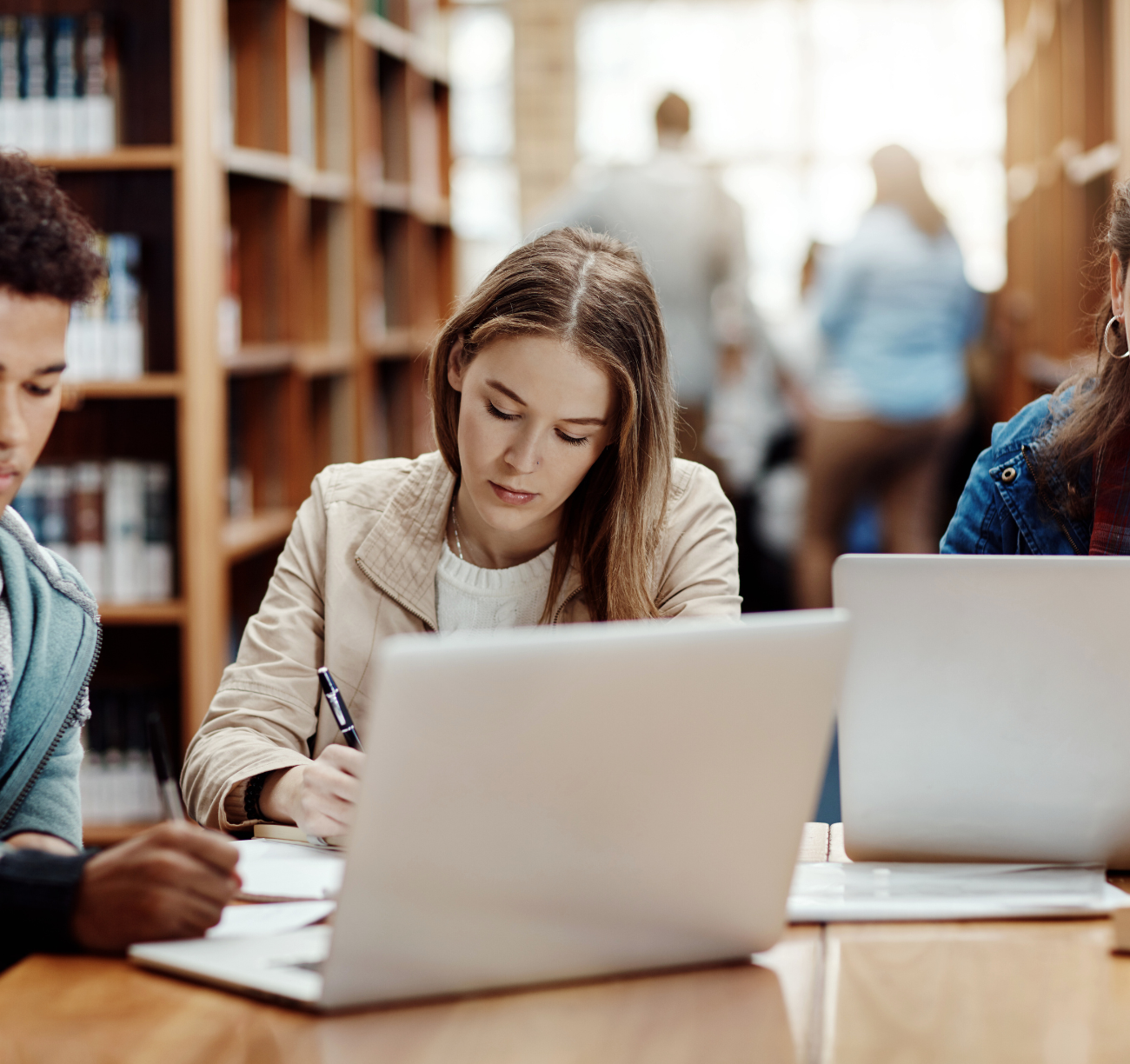 Explore and Learn Young couple researching home loan options on laptop in a library setting